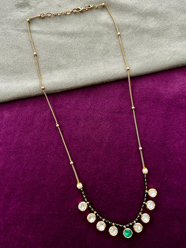 Necklace with circular pendants on a purple fabric background