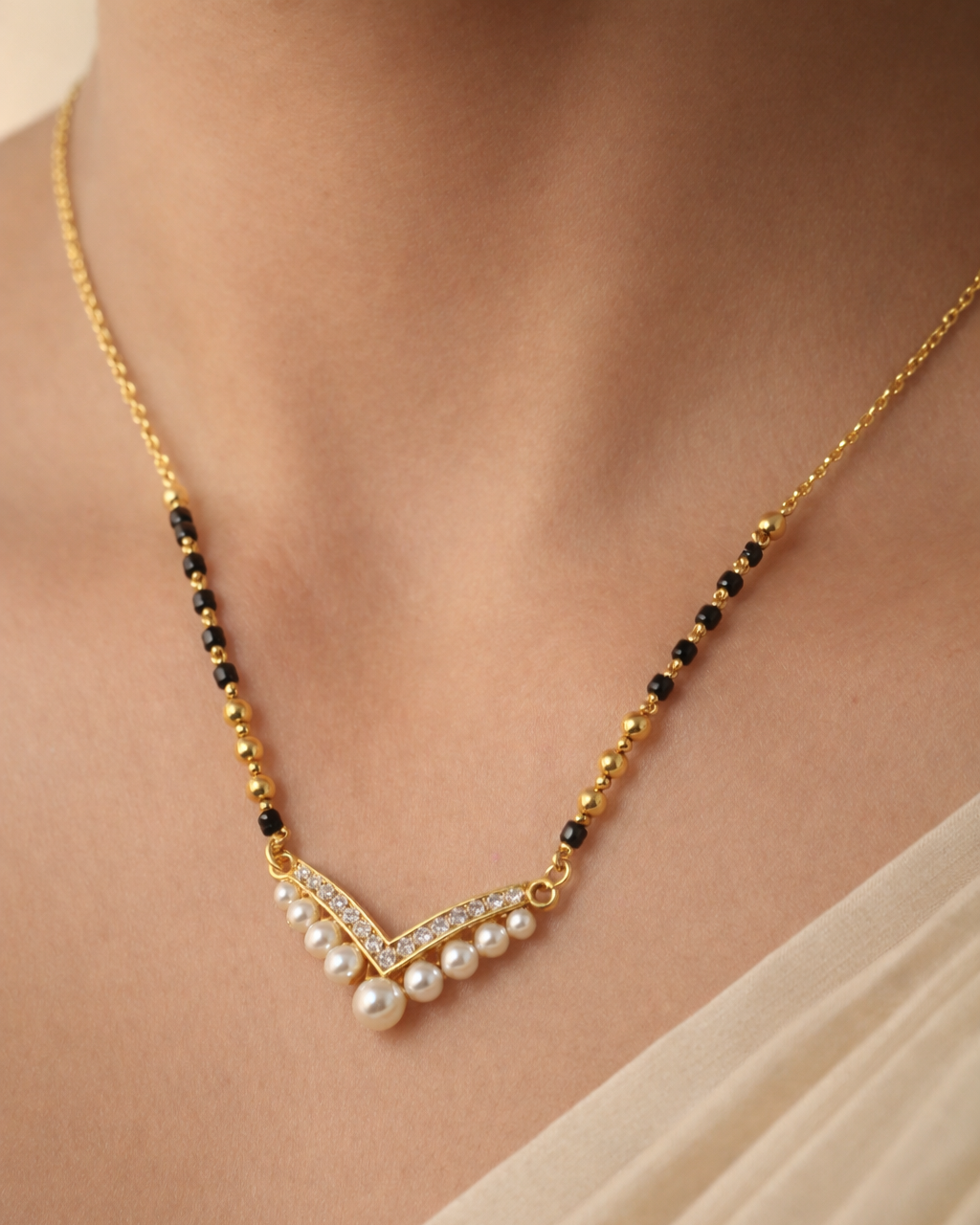 Gold-polish mangalsutra featuring a pearl and diamond-style V-shaped pendant