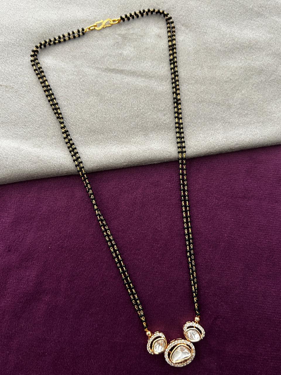 Necklace with pendant on a purple and gray fabric background