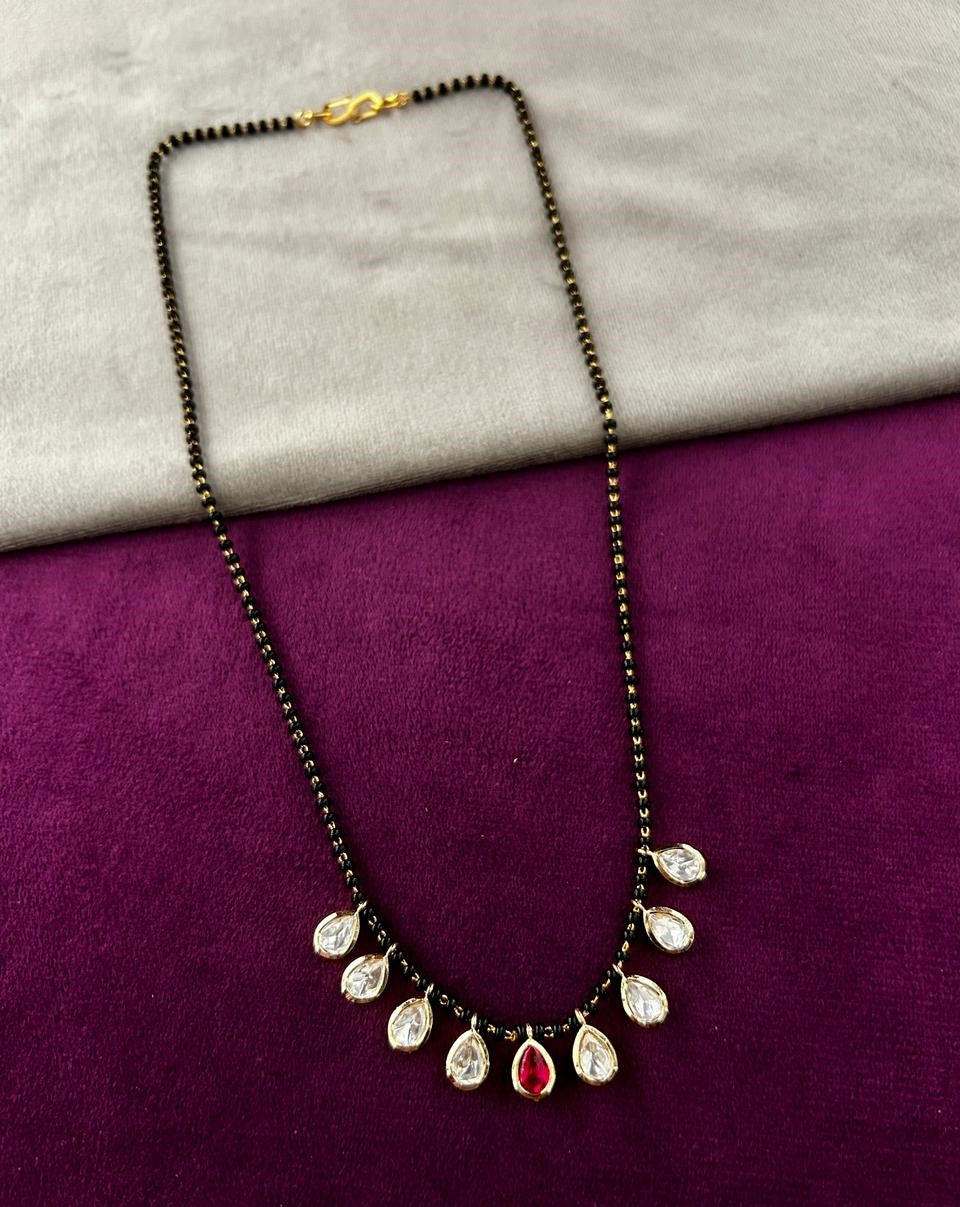 Necklace with pendant on a purple and gray fabric background