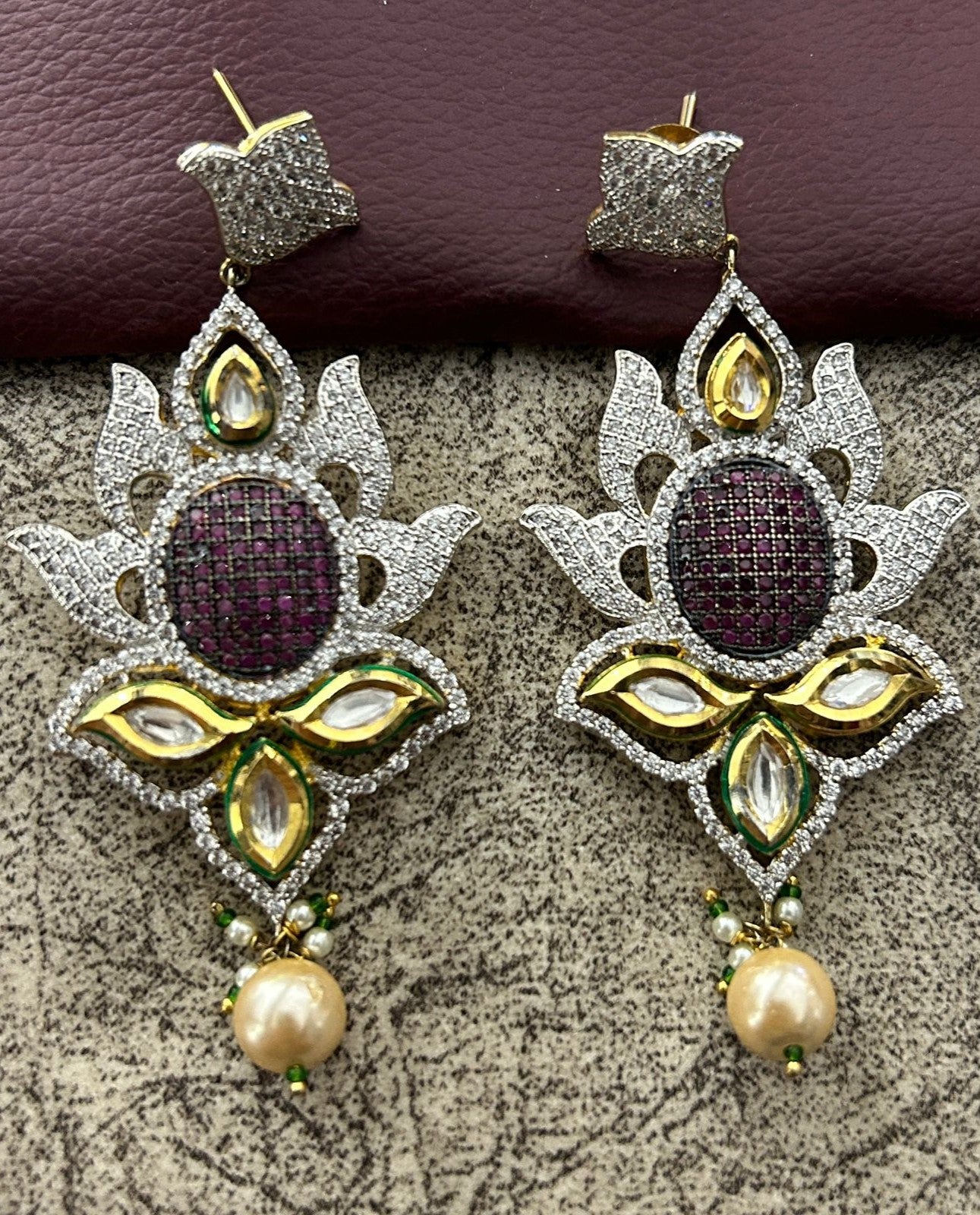 Ornate earrings with gemstones and pearls