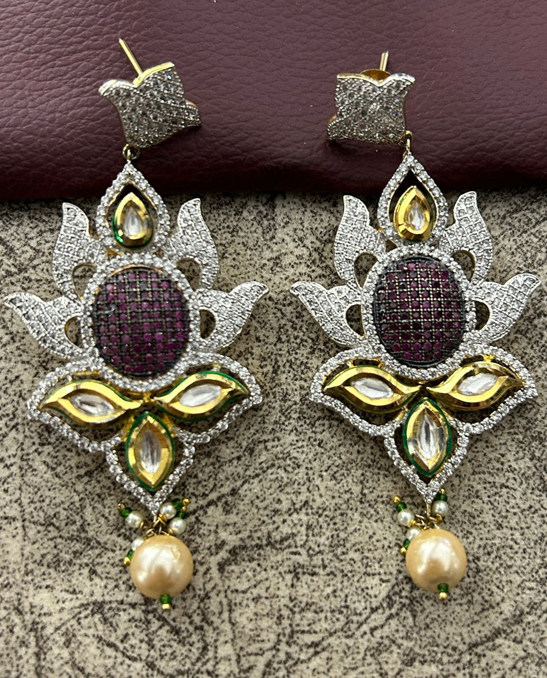 Ornate earrings with gemstones and pearls