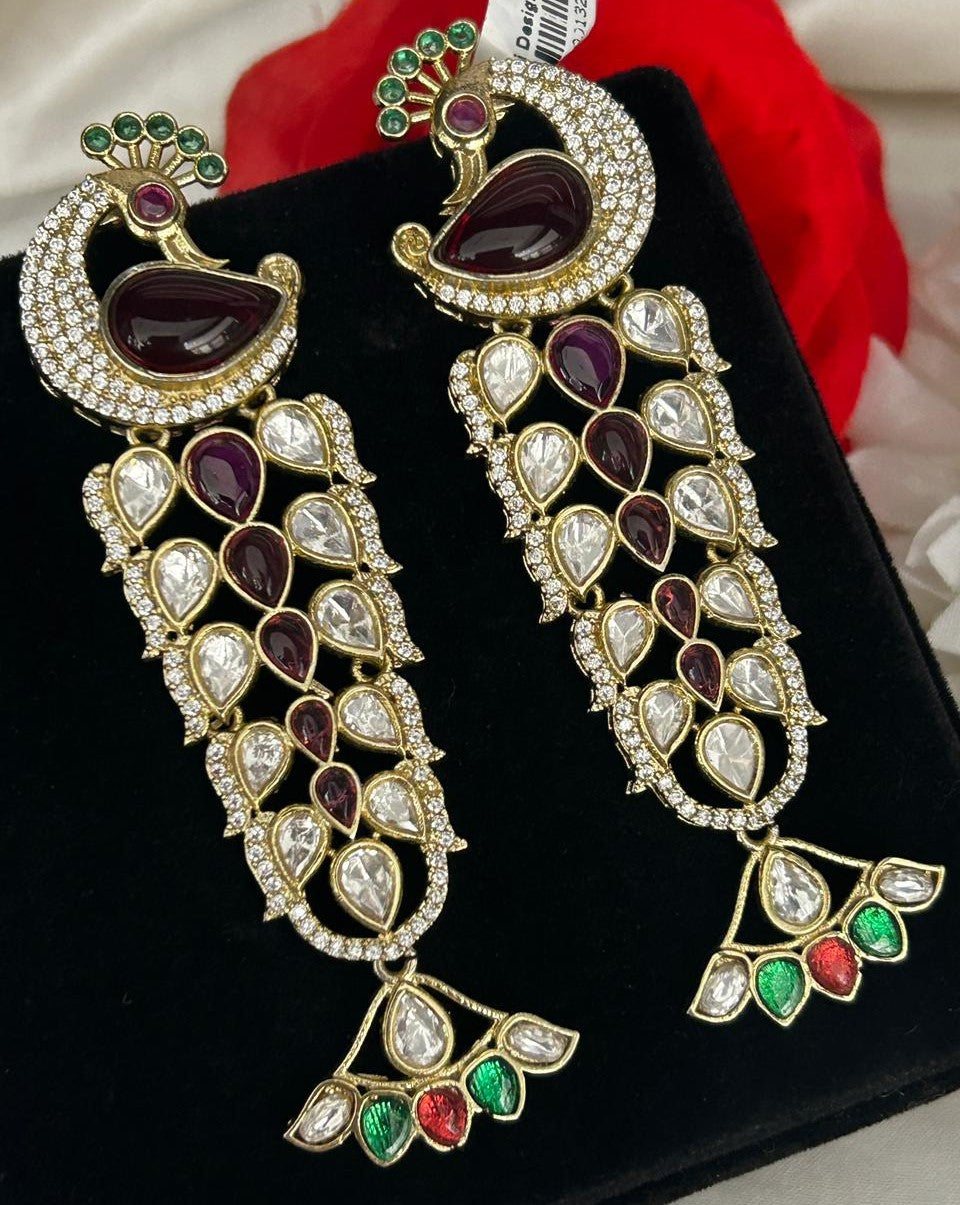 Ornate earrings with gemstones on a black surface