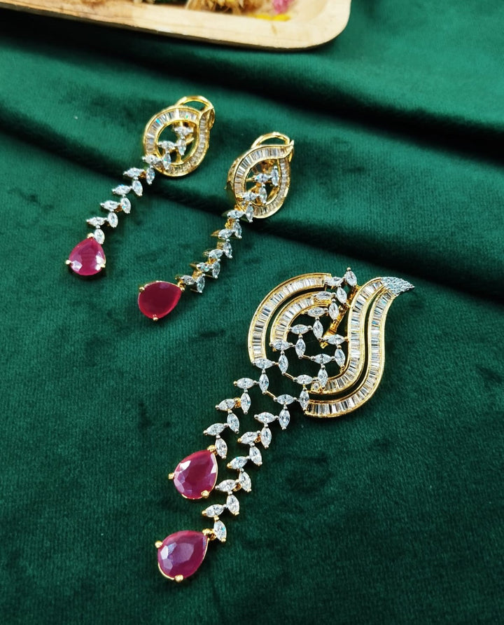 Designer gold toned pendant set featuring ruby red drop stones with diamond look detailing, statement jewellery for sale