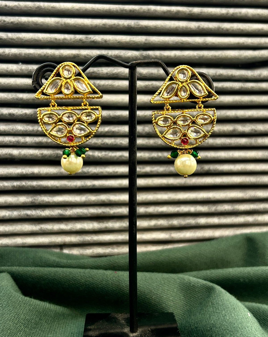 Traditional jewellery ensemble crafted with pearl strands, green beads, and structured pendant design