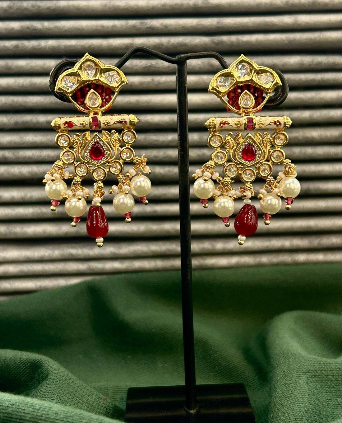 Traditional jewellery ensemble featuring pearl accents and ruby-toned kundan work