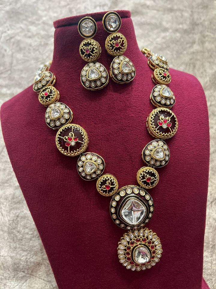 Ornate necklace and earrings set on a mannequin bust with a neutral background