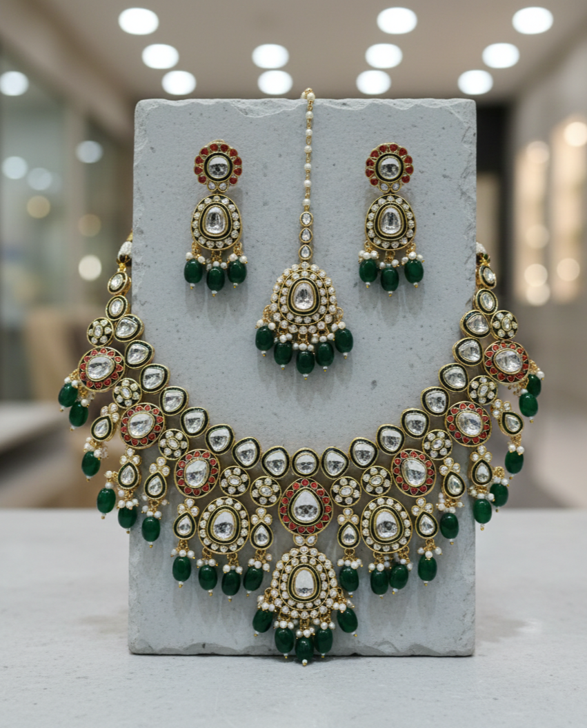 Green kundan bridal necklace set paired with matching earrings and maang tikka