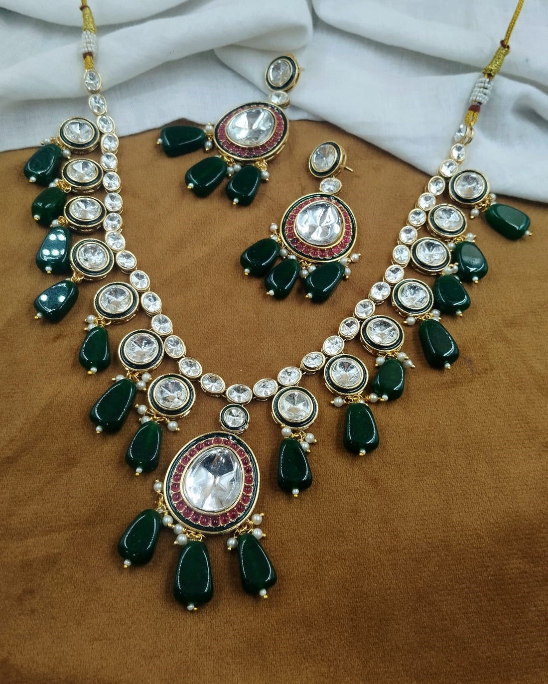 Traditional green kundan necklace featuring green bead drop detailing with matching earrings