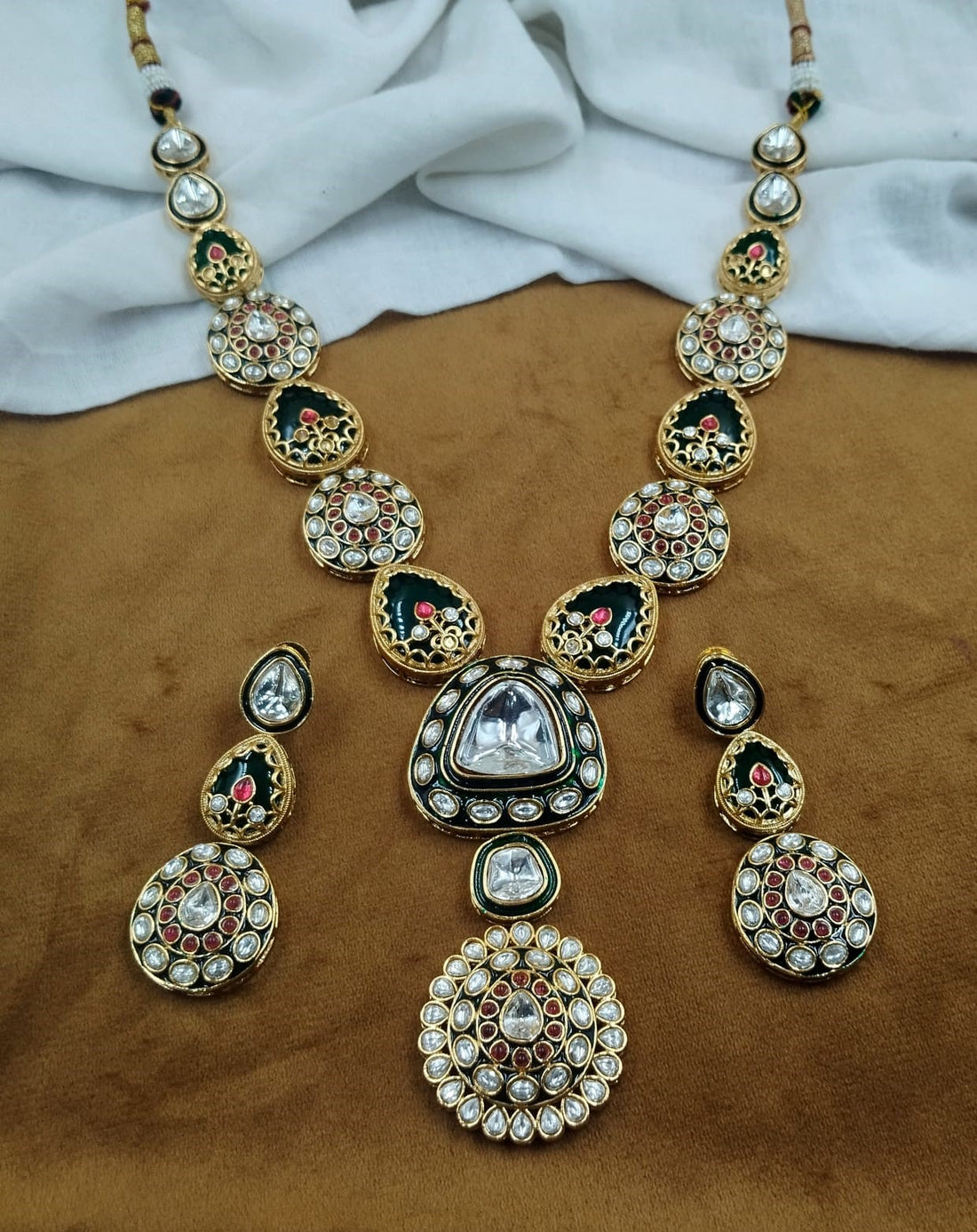 Traditional green kundan necklace featuring red stone detailing, ethnic Indian design