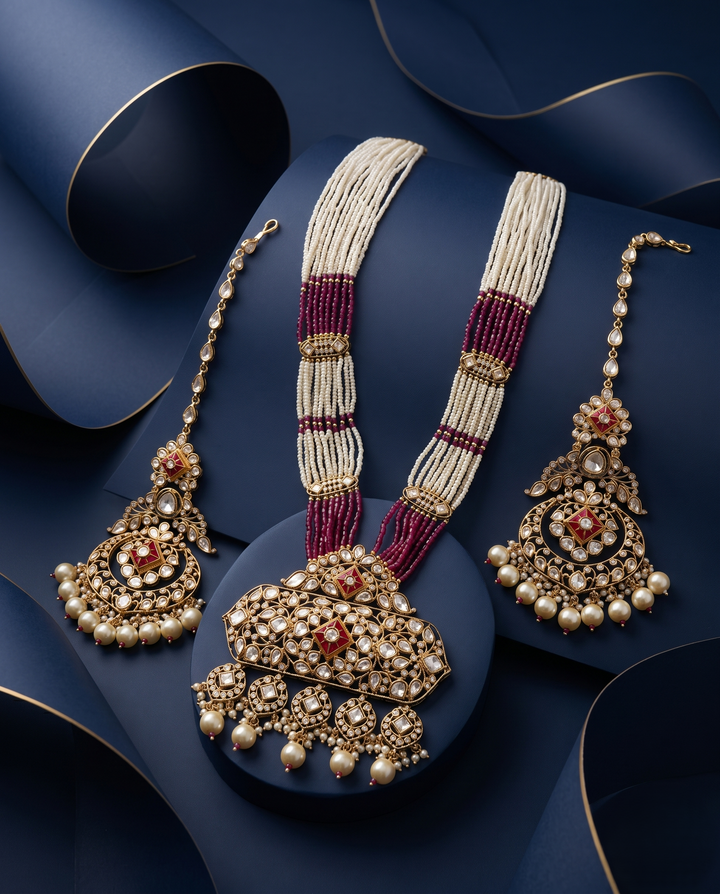 Ornate necklace with pearls and red stones on a dark blue background