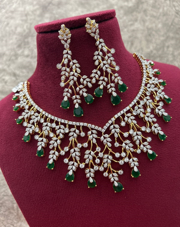 Ornate necklace and earrings set on a mannequin bust with a neutral background