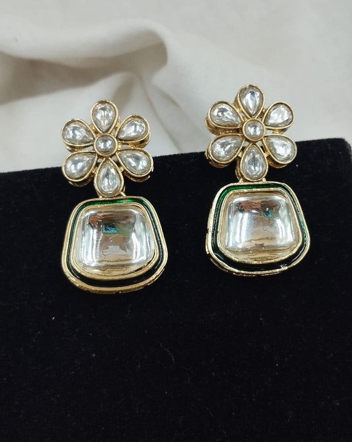 Elegant necklace and earring set highlighted by geometric kundan design and floral accents