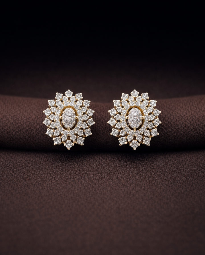 Pair of diamond earrings on a dark brown fabric background