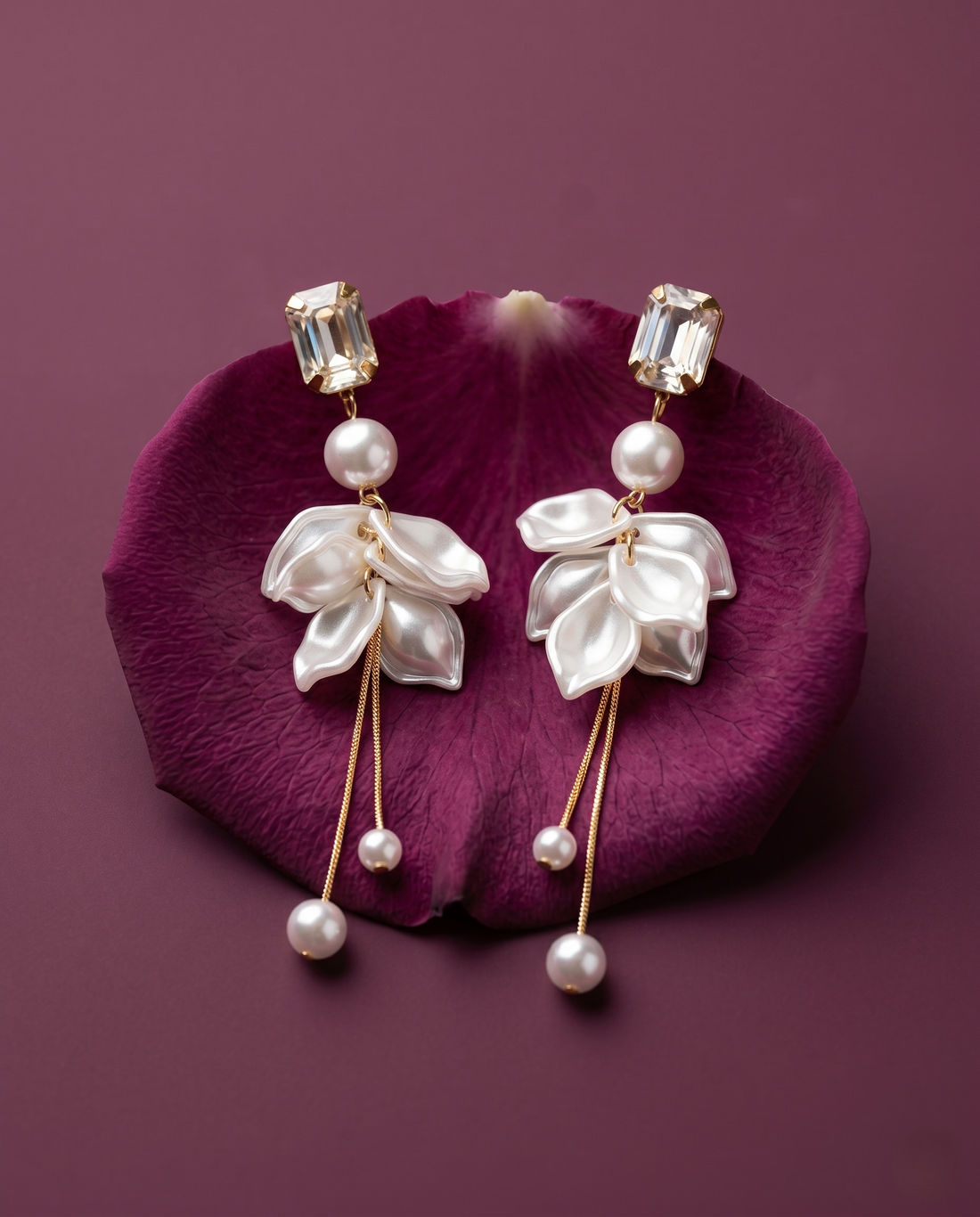 Pair of earrings with floral design on a purple petal