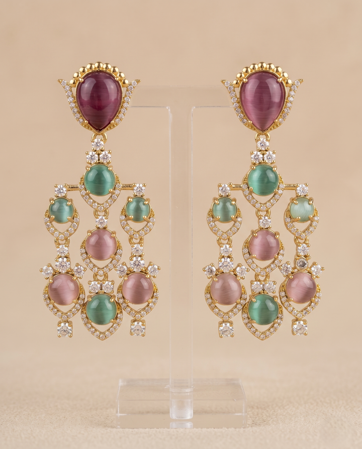 Pair of ornate earrings gemstones a beige background