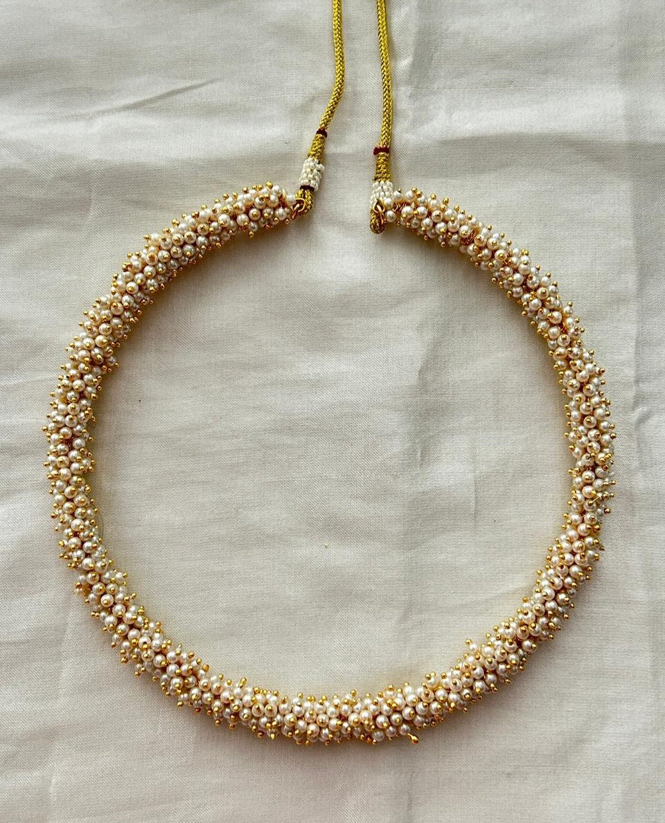Pearl necklace on a light fabric background