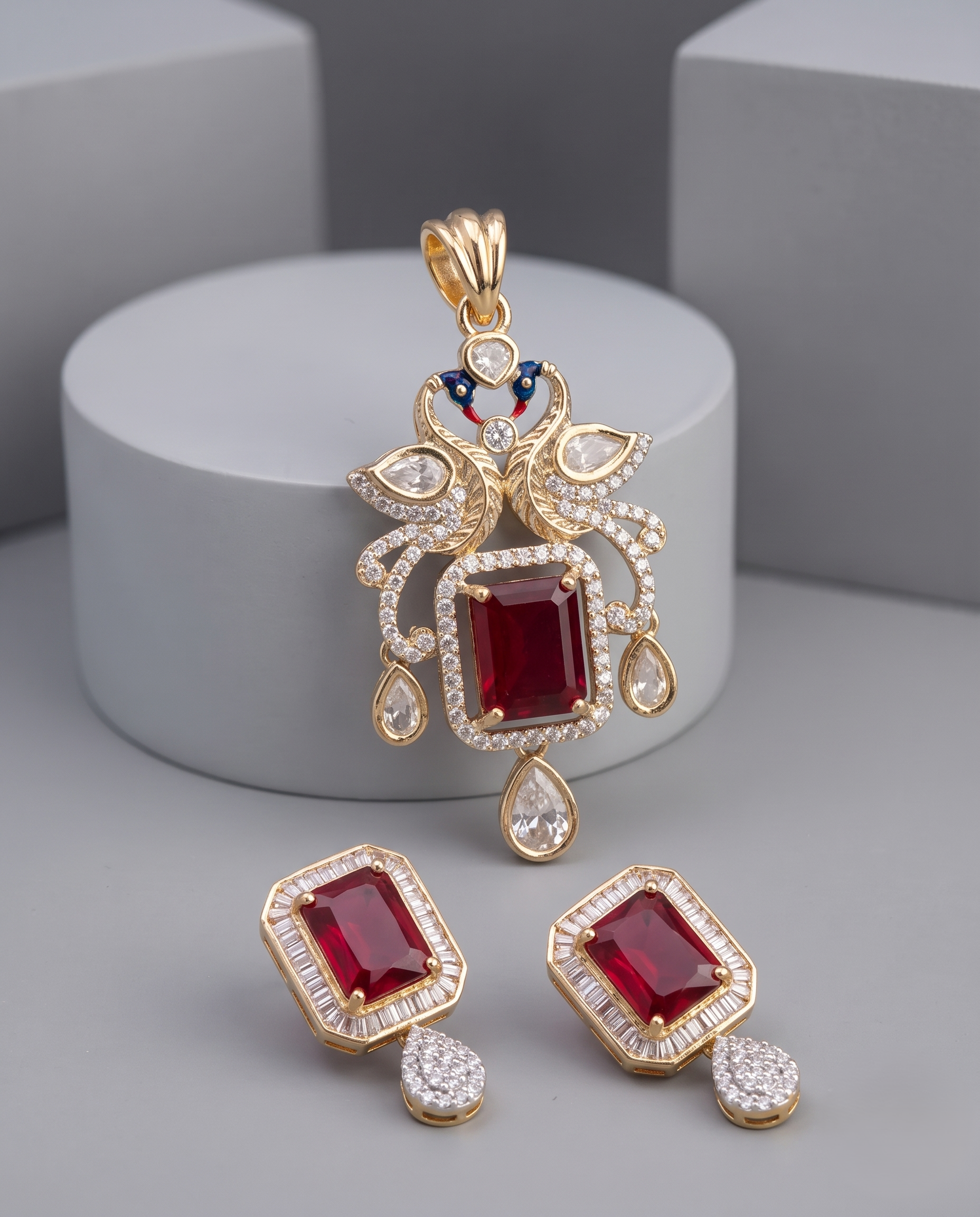 Gold-plated jewelry set featuring a pendant and matching earrings with rectangular red gemstones.