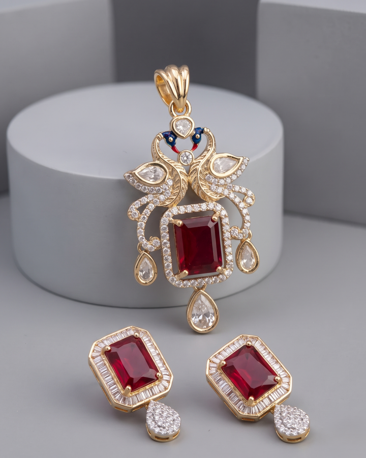 Gold-plated jewelry set featuring a pendant and matching earrings with rectangular red gemstones.
