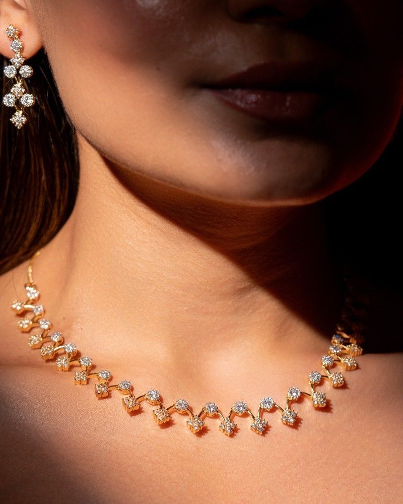 Rose gold necklace with diamonds on a dark background