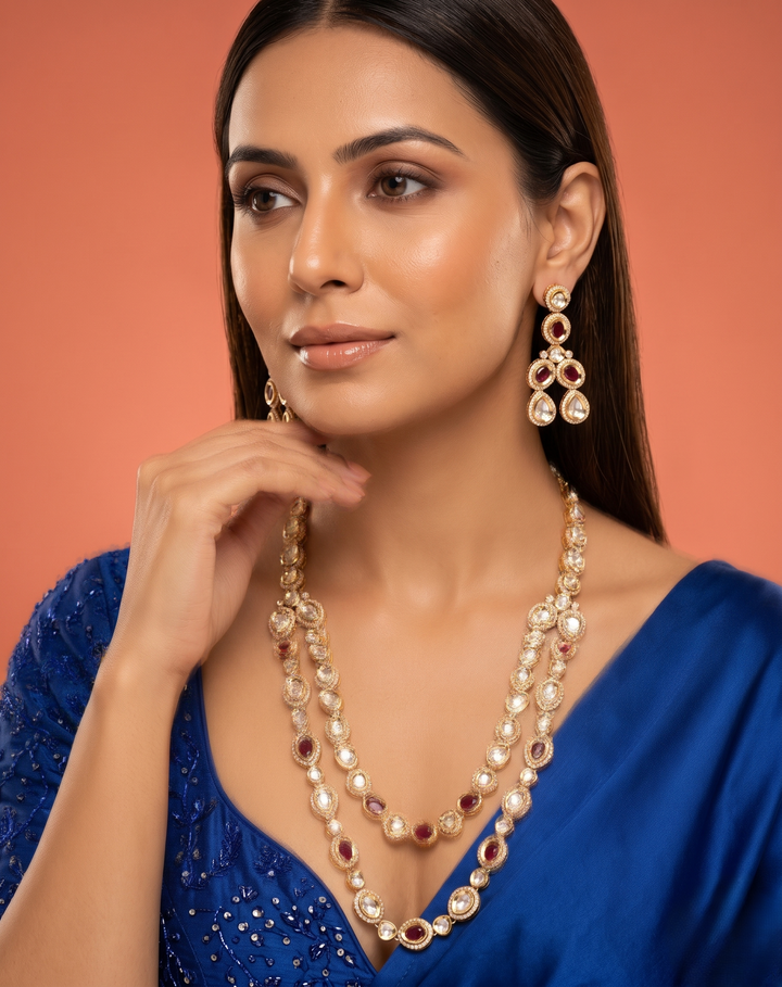 Woman wearing a necklace and earrings against an orange background