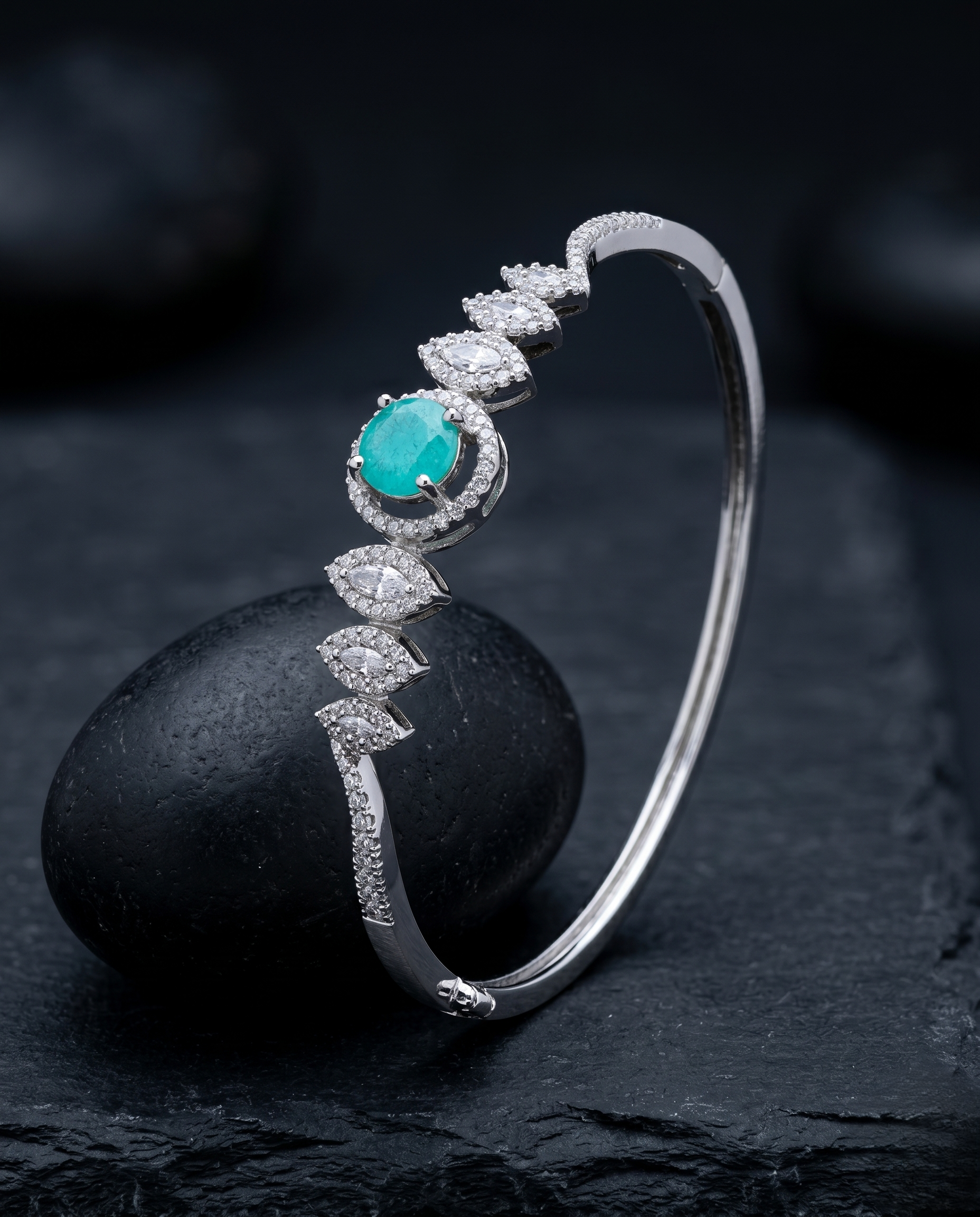 Silver bracelet with a turquoise stone and diamonds on a dark surface