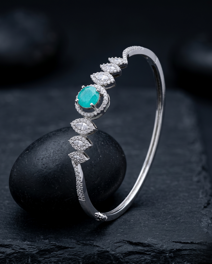 Silver bracelet with a turquoise stone and diamonds on a dark surface