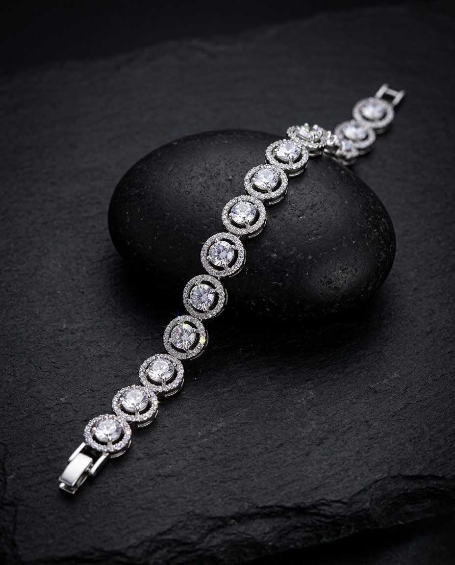 Silver bracelet with clear stones on a dark stone surface
