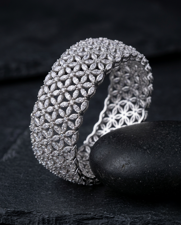 Silver bracelet with diamond-like stones on a dark surface