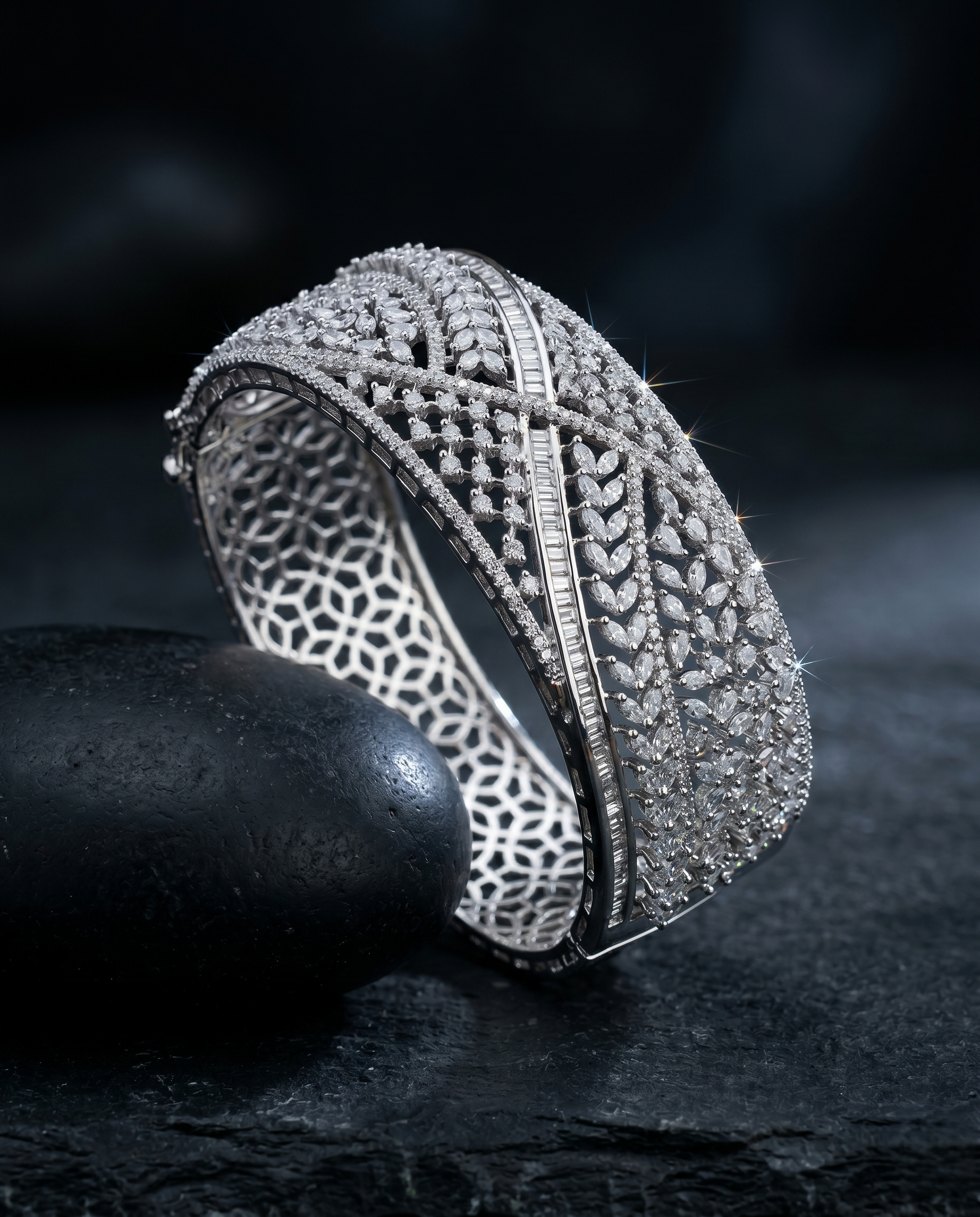 Silver bracelet with intricate design on a dark background
