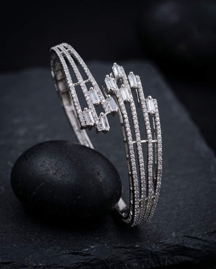 Silver bracelet with intricate design on a dark surface