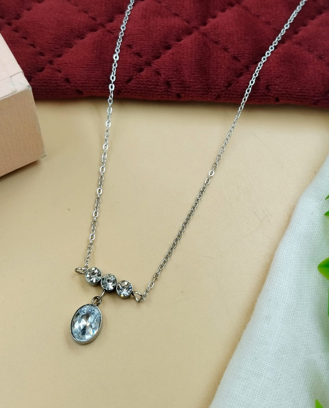 Oval drop pendant necklace crafted with sparkling stone detailing in silver tone