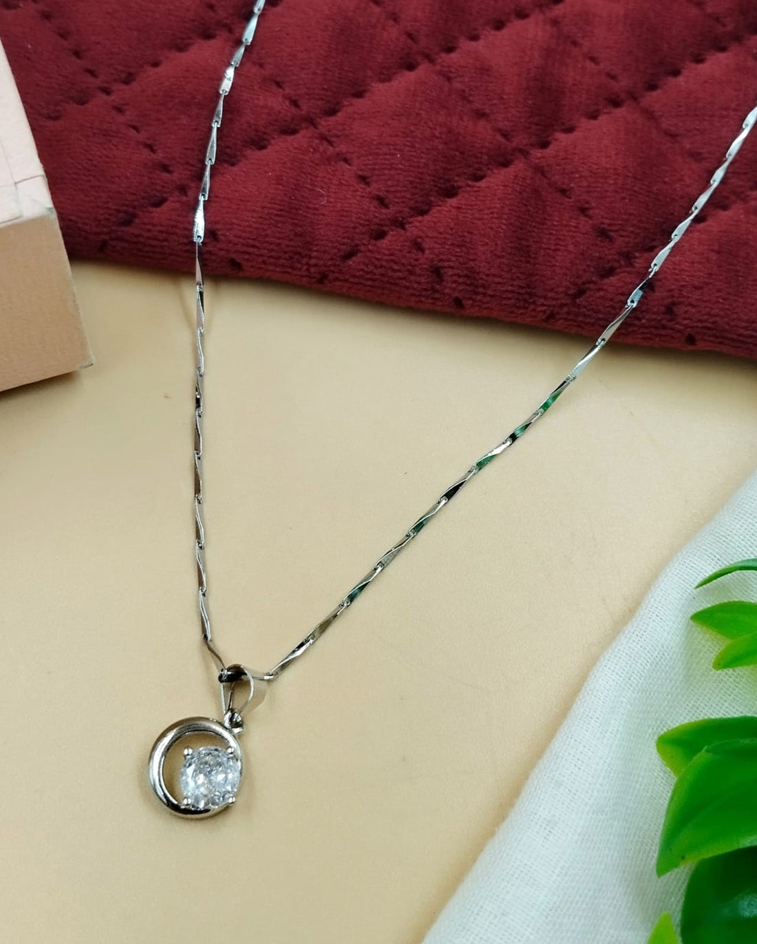 Round-cut solitaire pendant necklace crafted in a sleek silver tone