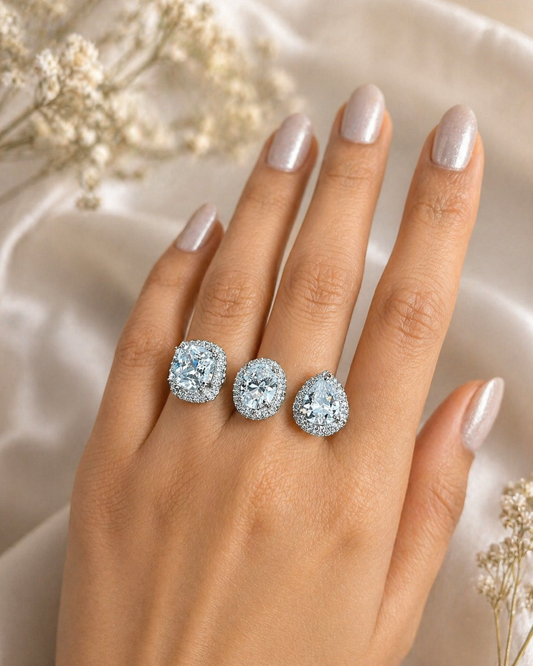 Silver ring with white gemstones on a white surface with  gypsy 
