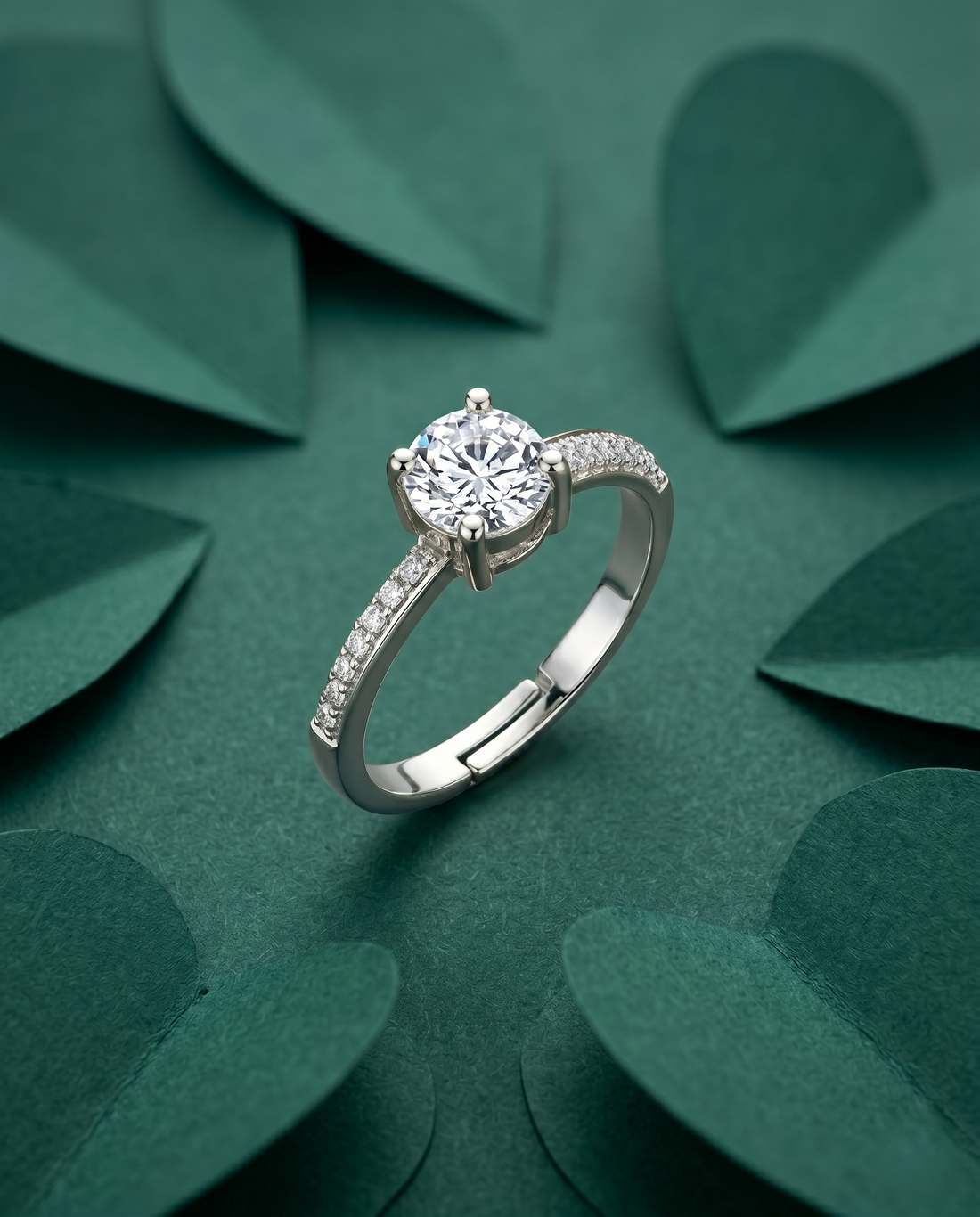 Silver ring with a diamond on a green leafy background
