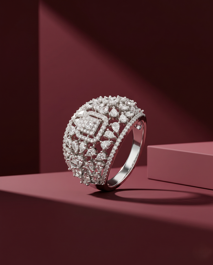 Silver ring with diamond accents on a pink platform against a red background