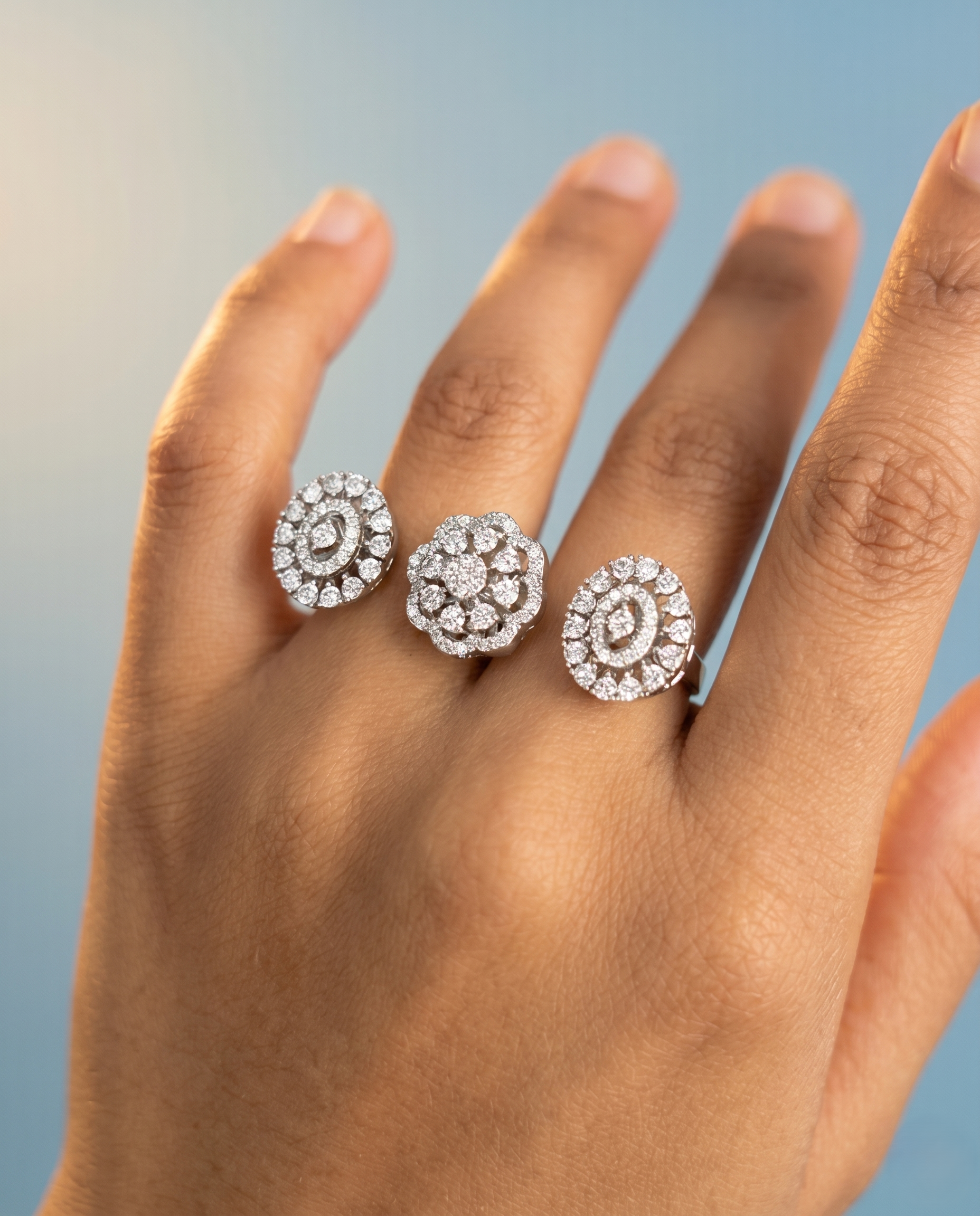 Three diamond rings on a hand with a blurred background