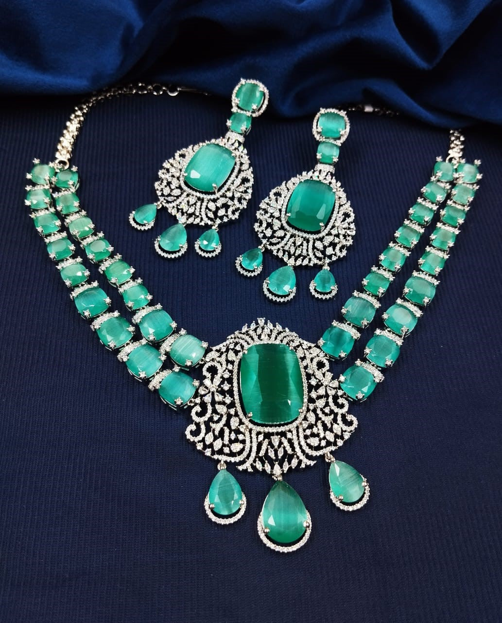 Silver finish diamond style necklace set featuring green stone detailing with earrings