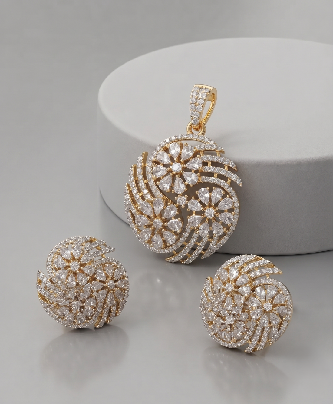 Premium gold-plated floral swirl pendant set featuring dazzling CZ stones and matching earrings 