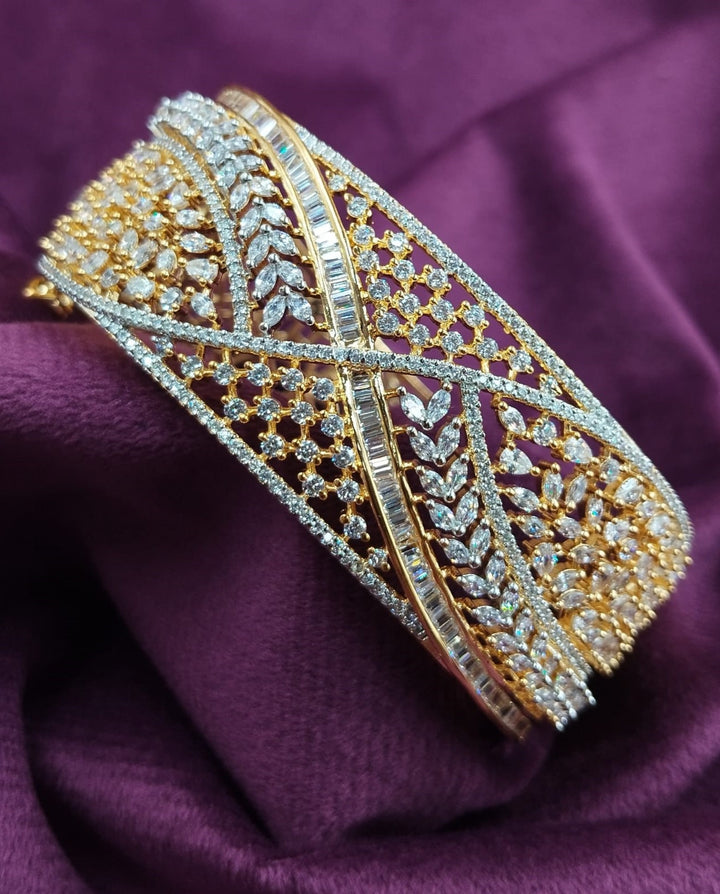 Gold and silver bracelet on a purple fabric background