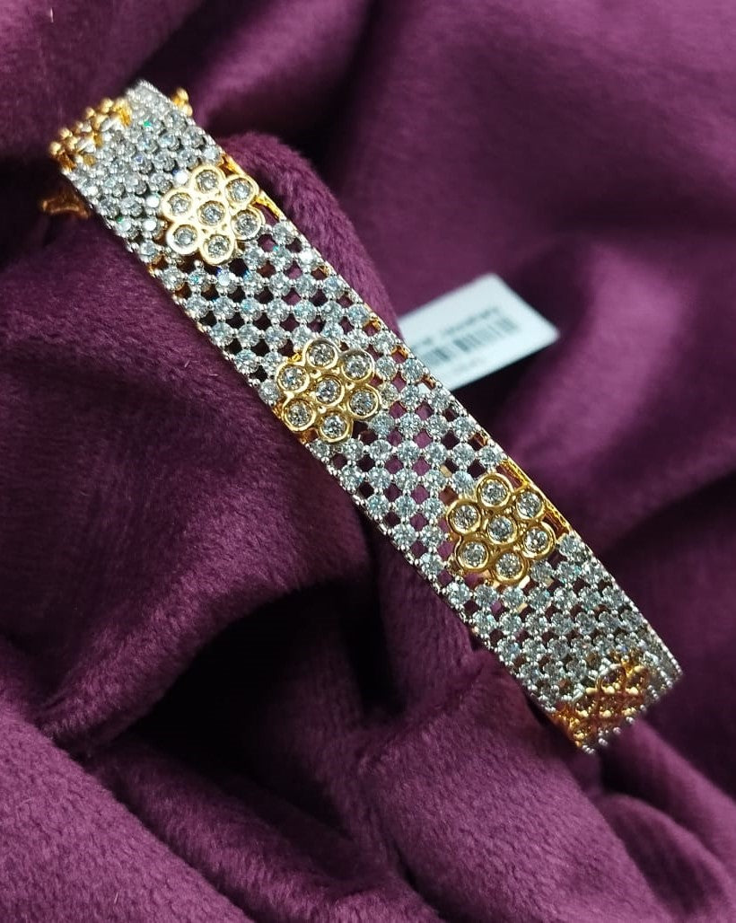 Gold and silver bracelet on a purple fabric background