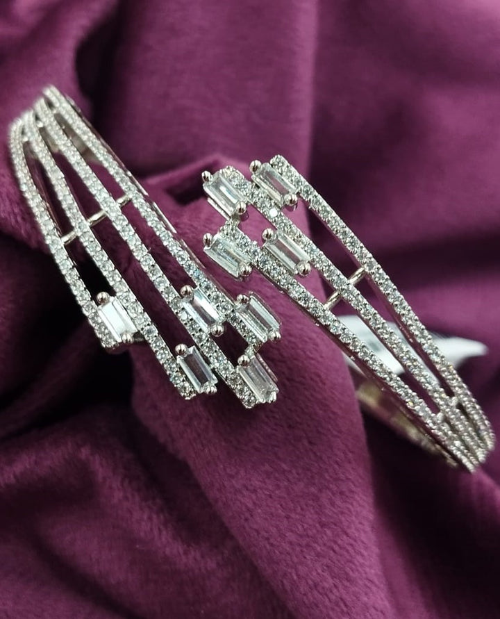 Silver bracelet with gemstones on a purple fabric background