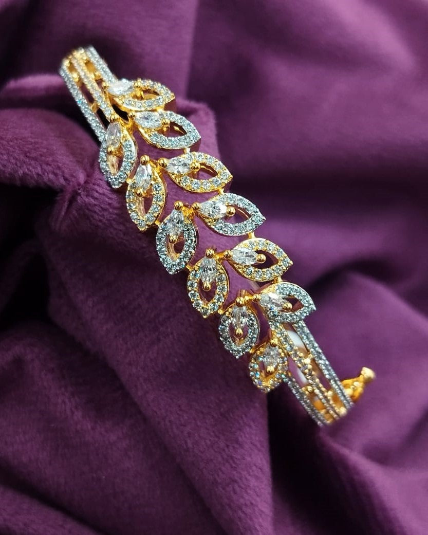 Gold and diamond bracelet on a purple fabric background
