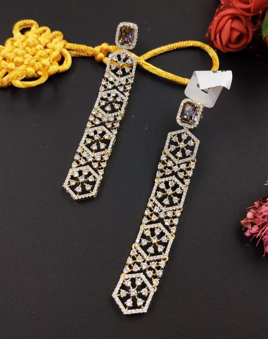 Decorative earrings with geometric pattern on a dark background