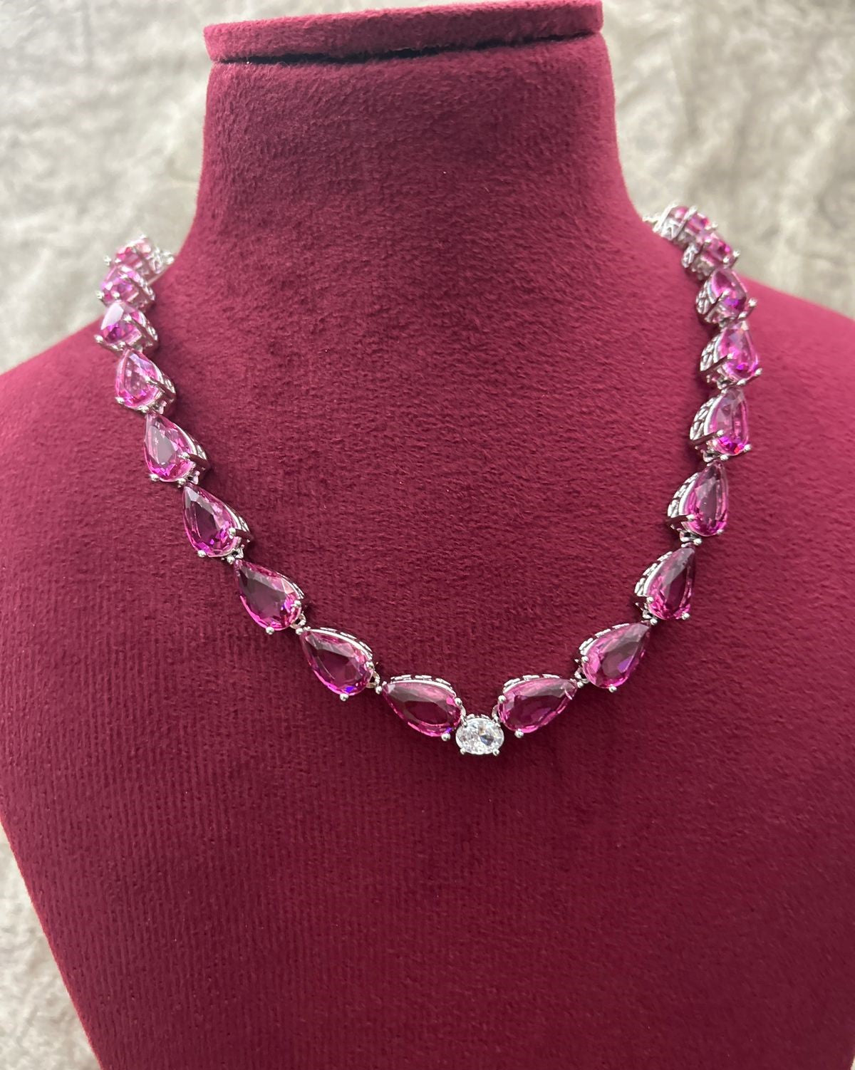 Necklace with pink gemstones on a mannequin bust