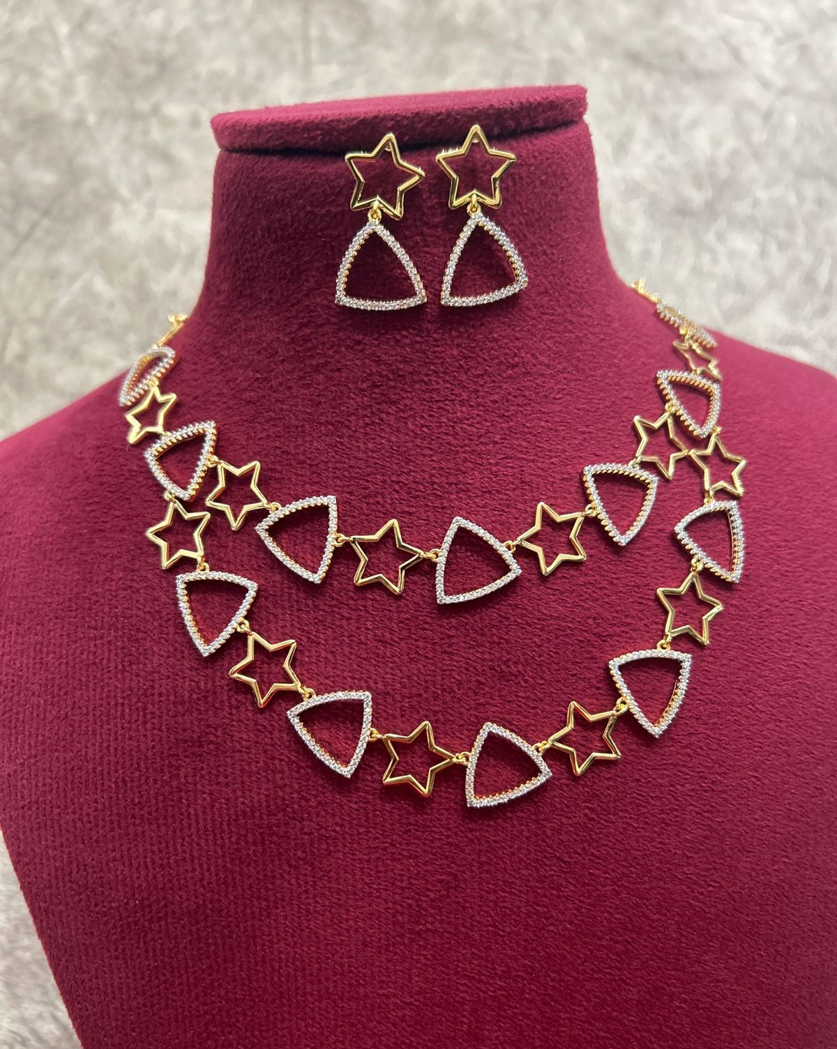 Jewelry set with necklace and earrings on a mannequin bust.