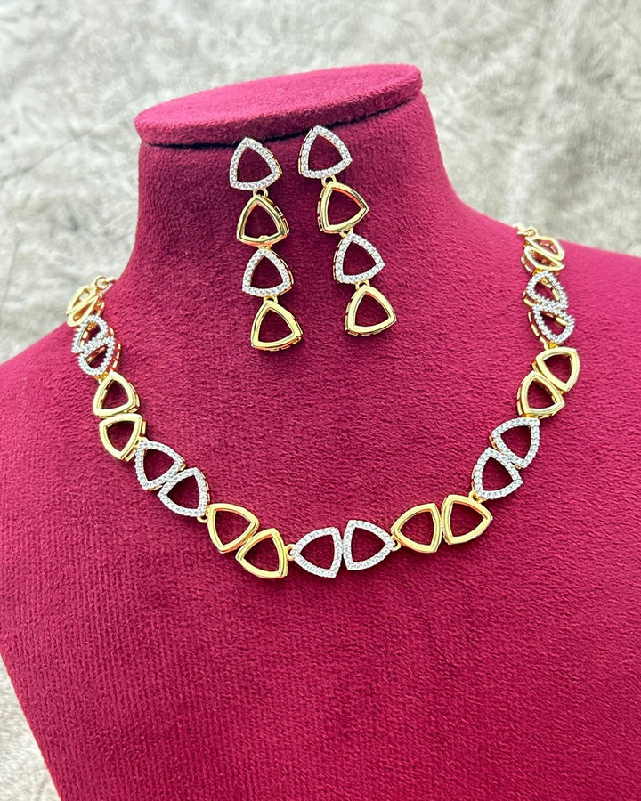 Jewelry set with necklace and earrings on a pink mannequin bust.
