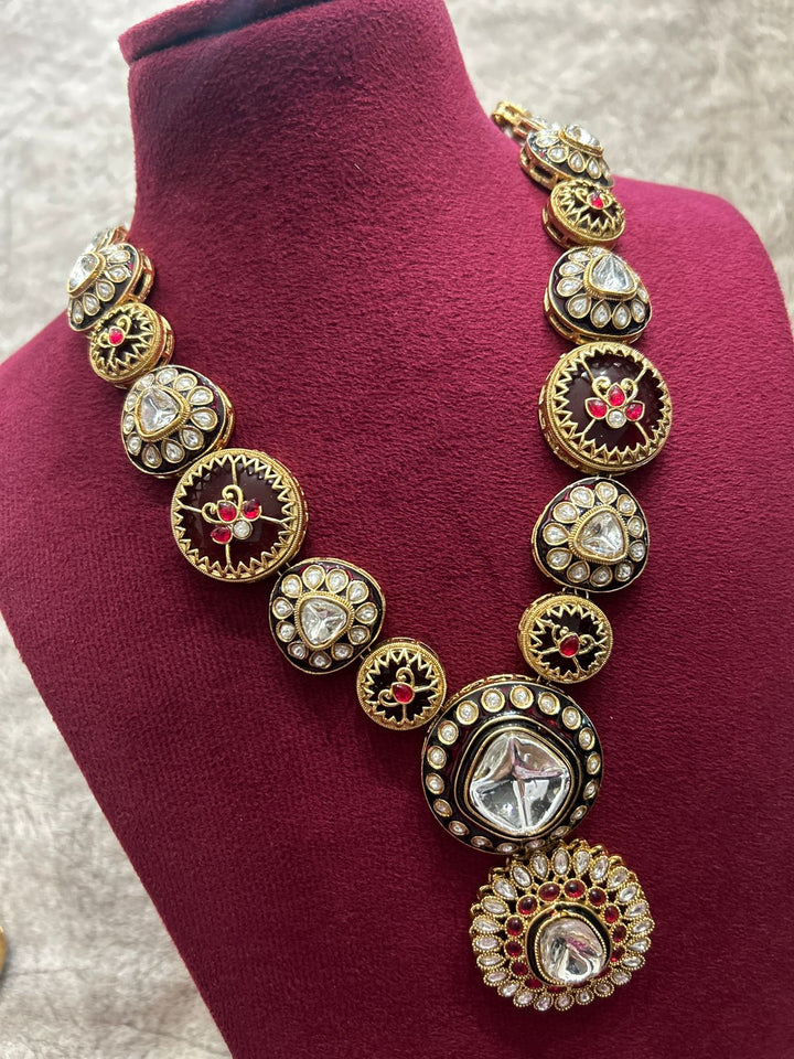 Decorative necklace on a mannequin bust with a maroon background