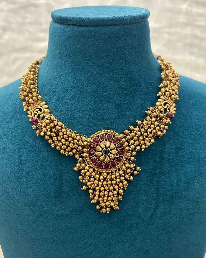 Antique Gold Ghunghroo Beaded Necklace Set with Floral Pendant and Matching Earrings
