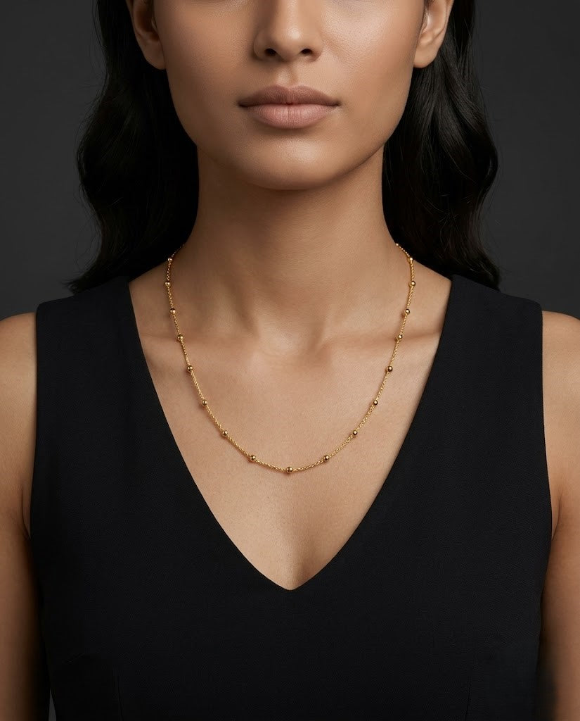 Woman wearing a gold against a dark background